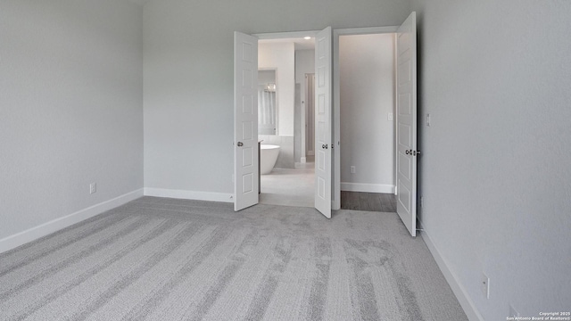 1716 Madden Hvn, San Antonio, TX 78245 - unfurnished bedroom with carpet flooring, ensuite bathroom, and baseboards