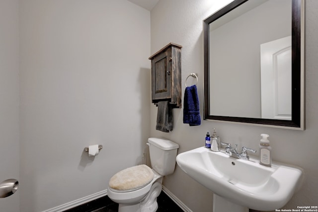 bathroom featuring sink and toilet