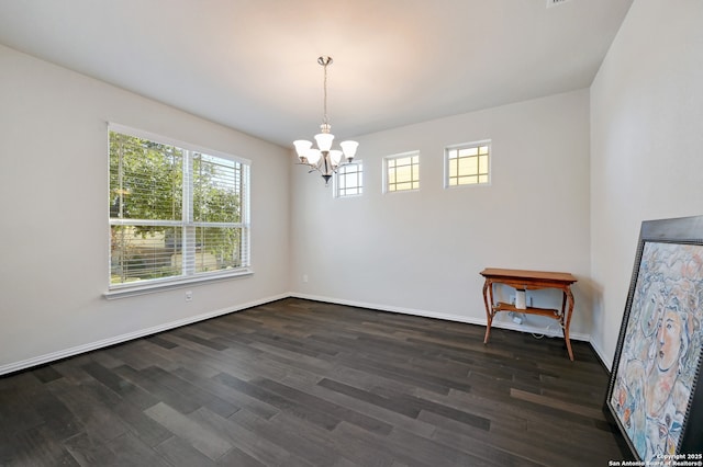 unfurnished dining area with dark wood-type flooring and a notable chandelier