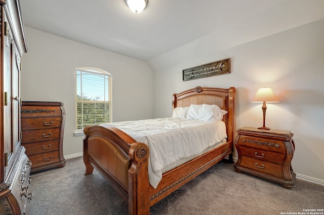 bedroom featuring vaulted ceiling and dark carpet