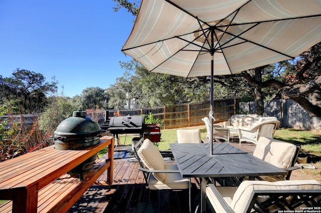 deck with grilling area and an outdoor living space