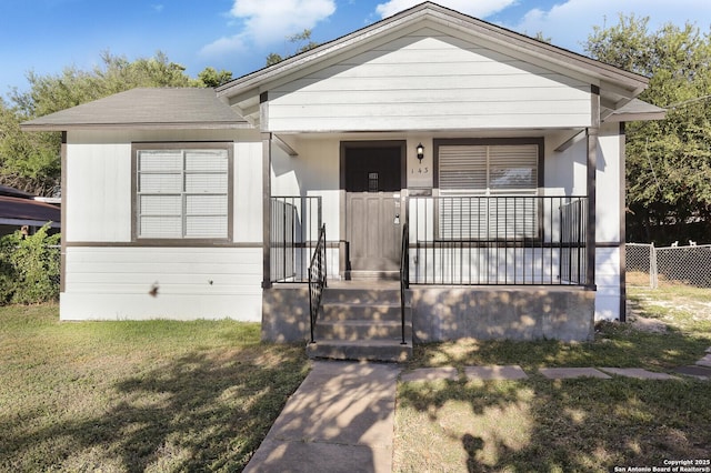 view of front facade with a front yard and a porch