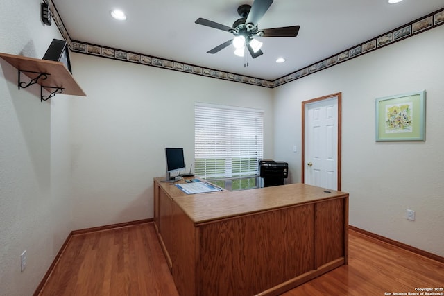 unfurnished office with ceiling fan and light hardwood / wood-style floors