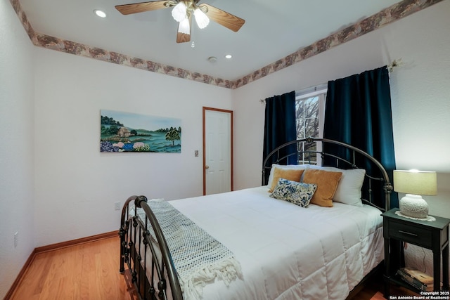 bedroom with ceiling fan and light hardwood / wood-style floors