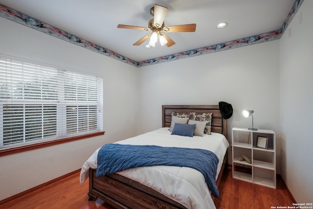 bedroom featuring hardwood / wood-style floors and ceiling fan