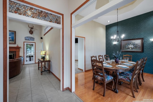 dining room with light tile patterned floors and a chandelier