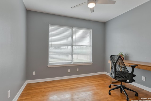 home office with ceiling fan, hardwood / wood-style flooring, and baseboards