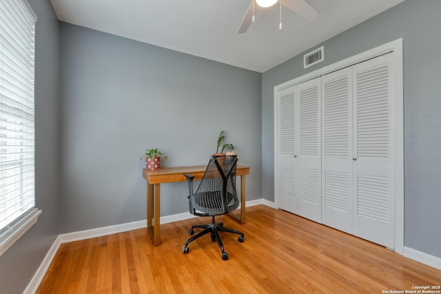 office featuring visible vents, baseboards, and wood finished floors