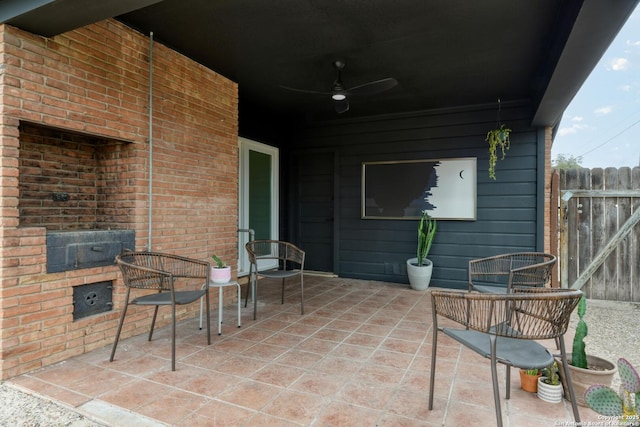 view of patio with a ceiling fan and fence