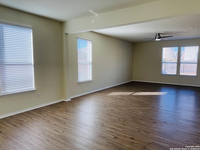 unfurnished room with dark hardwood / wood-style floors and ceiling fan