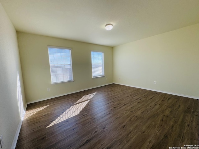 unfurnished room with dark hardwood / wood-style floors