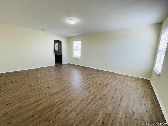 spare room with wood-type flooring