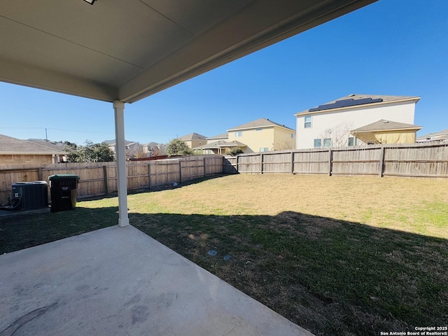 view of yard with central AC and a patio