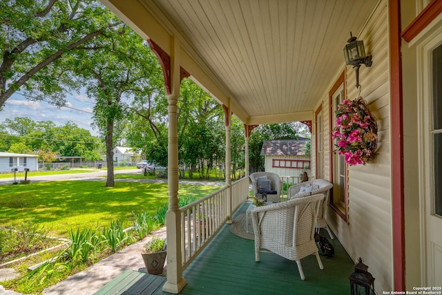 wooden deck with a porch and a yard