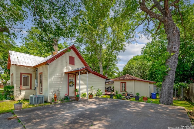 view of front of home with an outbuilding and central air condition unit