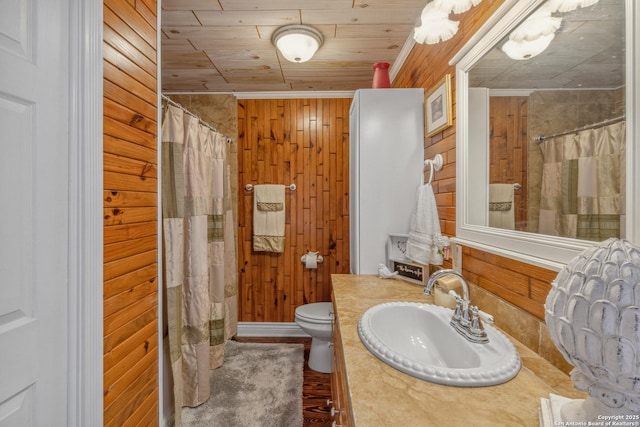 bathroom featuring toilet, wood ceiling, vanity, wooden walls, and a shower with shower curtain