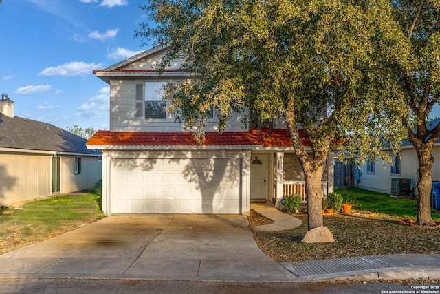 view of front of house featuring a garage and central air condition unit