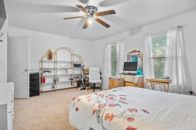 bedroom featuring light colored carpet and ceiling fan