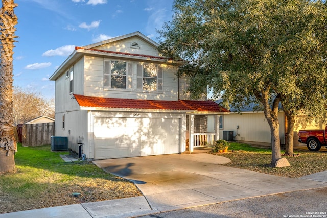 view of front facade with central AC, a garage, and a front yard