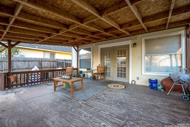 wooden terrace with a patio area and french doors