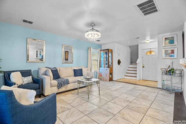 living room featuring a chandelier and light tile patterned flooring