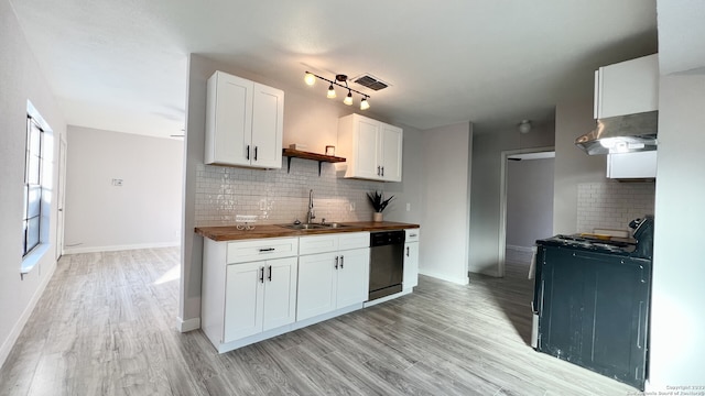 kitchen with wood counters, sink, light hardwood / wood-style flooring, stainless steel dishwasher, and white cabinets