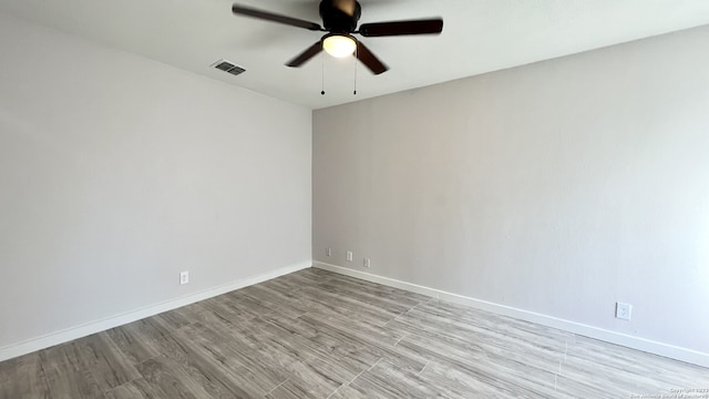 spare room with light hardwood / wood-style flooring and ceiling fan