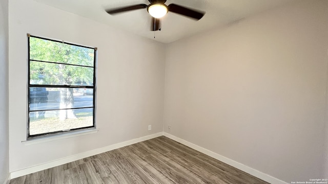 spare room with wood-type flooring and ceiling fan