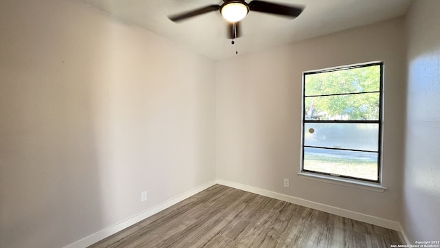 empty room with hardwood / wood-style flooring and ceiling fan