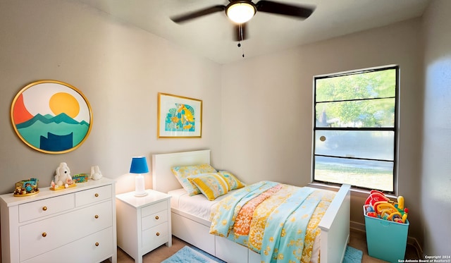 bedroom featuring ceiling fan and multiple windows