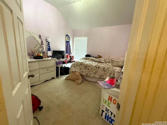 bedroom with vaulted ceiling and carpet flooring