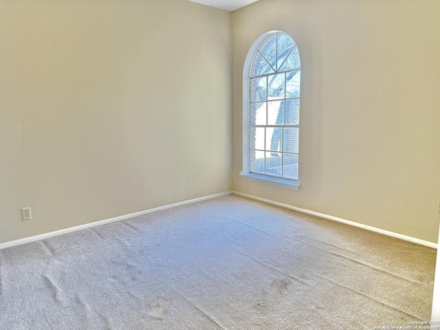 carpeted spare room featuring a healthy amount of sunlight