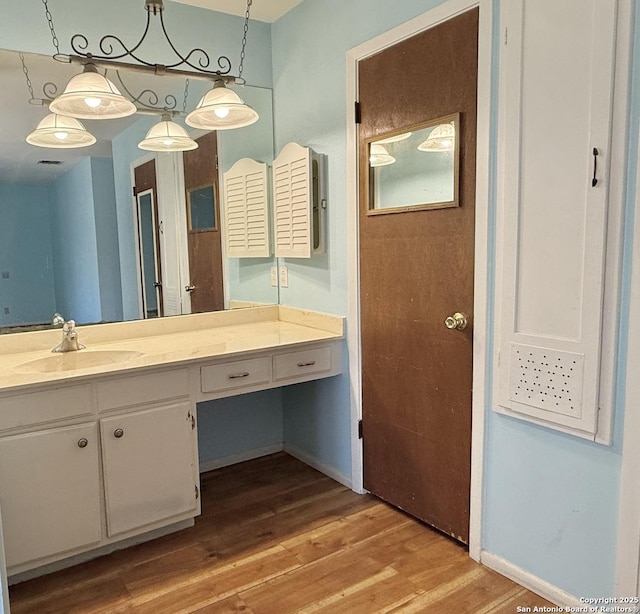 bathroom featuring hardwood / wood-style flooring and vanity