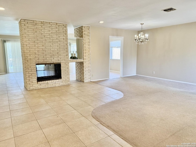 unfurnished living room with light tile patterned floors, a notable chandelier, and a fireplace