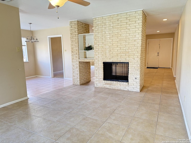 unfurnished living room featuring light tile patterned flooring, a brick fireplace, and ceiling fan with notable chandelier