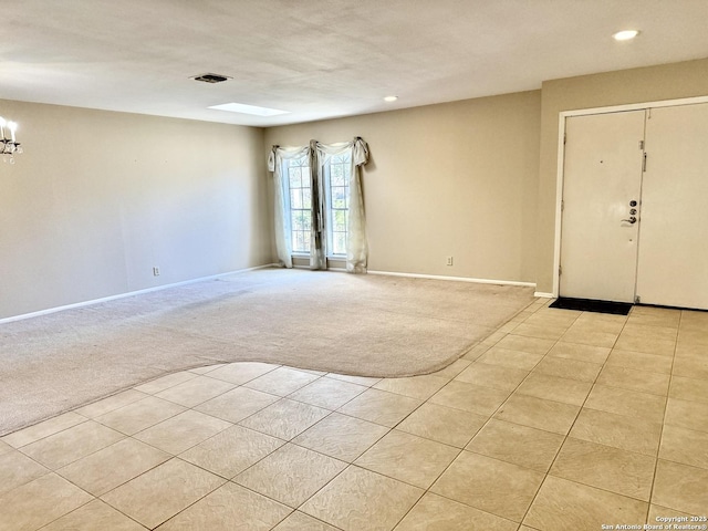 foyer entrance with light carpet