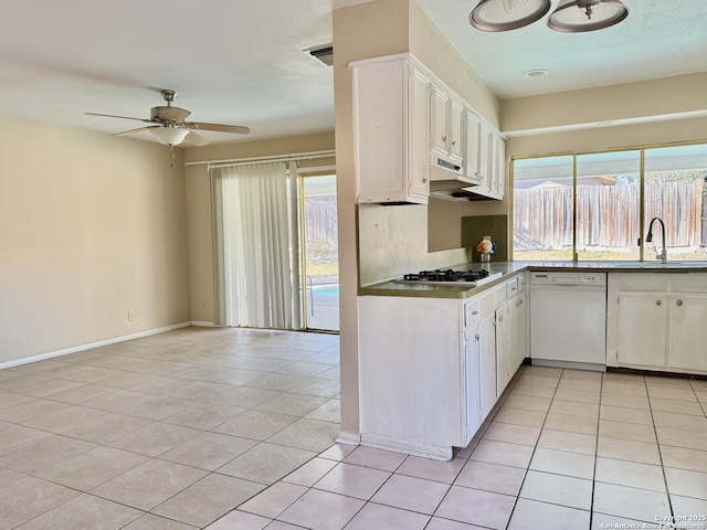 kitchen featuring white dishwasher, sink, white cabinets, and light tile patterned flooring