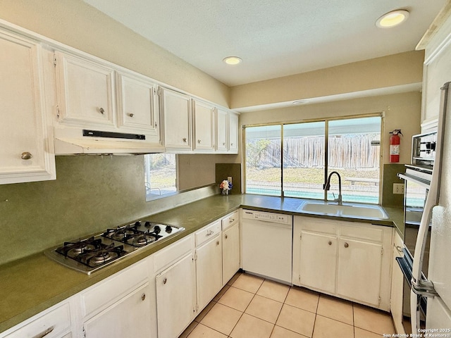 kitchen with stainless steel gas stovetop, dishwasher, sink, and white cabinets