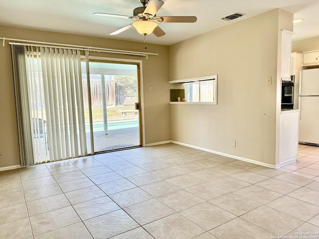 unfurnished room with ceiling fan and light tile patterned floors