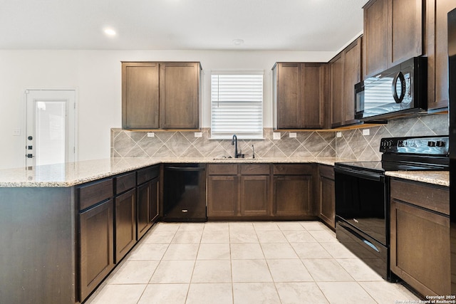 kitchen with sink, dark brown cabinets, black appliances, and light stone countertops