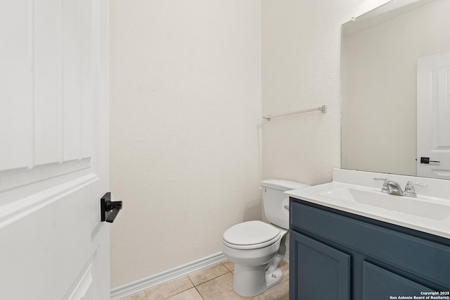 bathroom featuring tile patterned flooring, vanity, and toilet