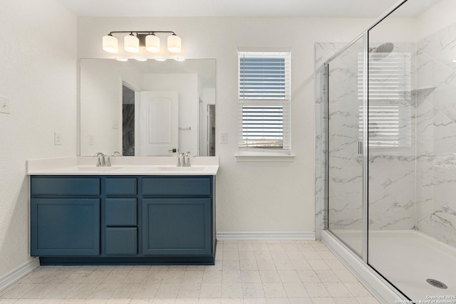 bathroom featuring vanity and a shower with door