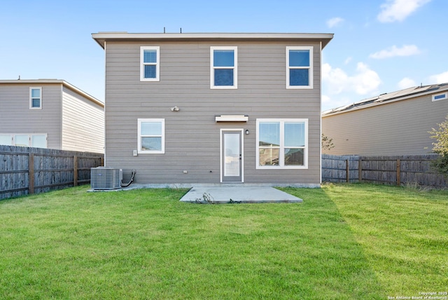 back of property featuring a patio, a lawn, and central air condition unit