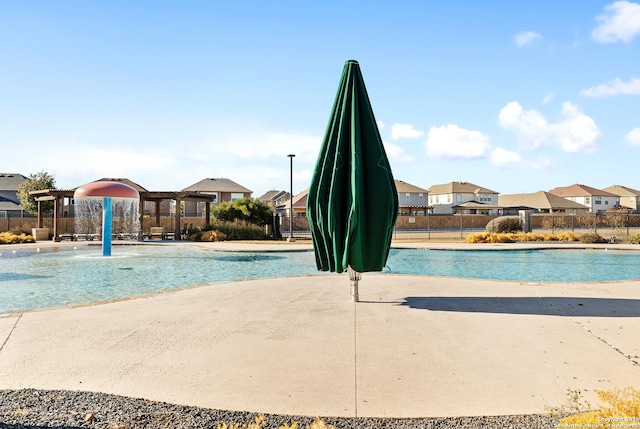 view of swimming pool with pool water feature