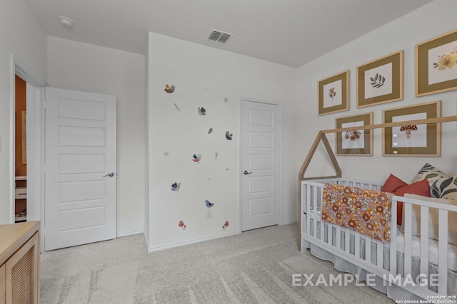 bedroom featuring a crib and light colored carpet