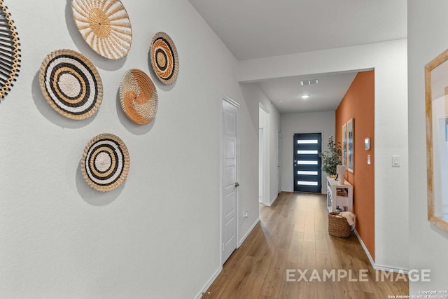 hallway with hardwood / wood-style flooring