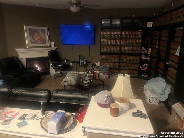 carpeted living room with ceiling fan