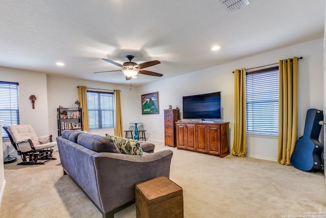 living room featuring light carpet and ceiling fan