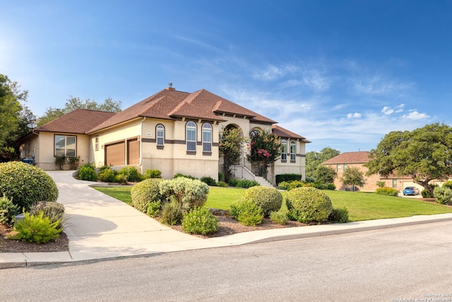 mediterranean / spanish home featuring a front lawn