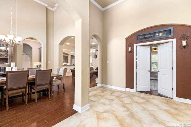 entrance foyer featuring ornamental molding and a notable chandelier